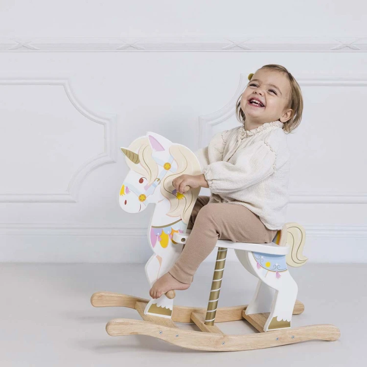 PL134-toddller-laughing-on-unicorn-carousel-rocking-horse.jpg
